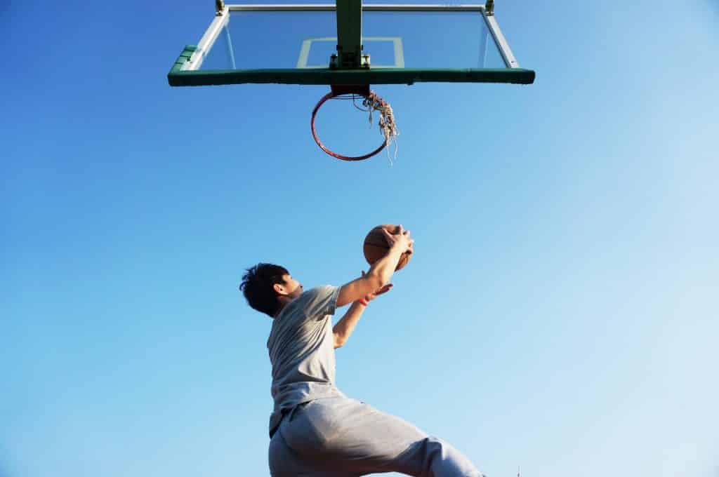 Homme jouant au basket en plein air